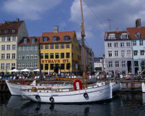 Nyhavn Harbour. Traditional waterfront buildings with groups of tourists and moored boats on waterDanish Danmark Northern Europe Scandinavia