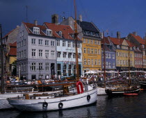 Nyhavn Harbour. Traditional waterfront buildings with crowds of tourists and moored boats on waterDanish Danmark Northern Europe Scandinavia