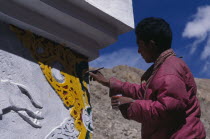 Young person repainting the temple exterior.Asia Bharat Inde Indian Intiya Religion Asian Religious Asia Bharat Inde Indian Intiya Religion Asian Religious