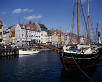 Nyhavn harbour. Traditional waterfront buildings with moored boats and a schooner in the foregroundDanish Danmark Northern Europe Scandinavia