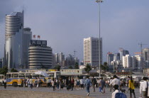 Special Economic Zone  city buildings  buses and crowds of pedestrians.