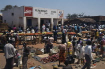 Crowded market scene  fruit and vegetable stalls with trading centre building behind.African Center Eastern Africa Malawian