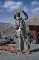 Elderly man using spindle to spin thread for rug making.carpet Male Men Guy Middle East Old Senior Aged Omani United Arab Emirates Al-Imarat Al-Arabiyyah Al-Muttahidah Arabic Emiriti Male Man Guy One...