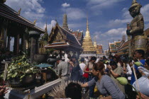 Crowds making offerings of incense and lotus flower buds at shrine in the Royal Palace during Lotus Flower Festival.Asian Prathet Thai Raja Anachakra Thai Religion Religious Siam Southeast Asia Siame...