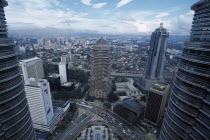 Elevated view over city framed by the Petronas Towers.Asian Gray Malaysian Southeast Asia Grey