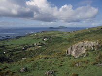 Scattered houses and farm buildings in green  coastal landscape near Ballybrack with outcrops of rock amongst yellow gorse in foreground.Eire European Irish Northern Europe Republic Scenic Ireland Po...