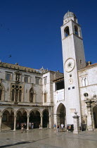 Bell tower and Sponza Palace  Luza Square  Stradun. Former YugoslaviaTravelTourismHolidayVacationAdventureExploreRecreationLeisureSightseeingTouristAttractionTourSponzaPalaceDubrovnikD...