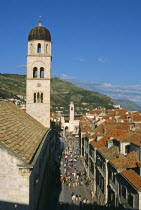 Franciscan Monastery  Stradun  bell tower at end of Stradun  red rooftops. Former YugoslaviaTravelTourismHolidayVacationAdventureExploreRecreationLeisureSightseeingTouristAttractionTourSt...