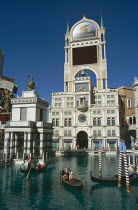 Venetian Hotel and Casino exterior with gondolas on the lake.