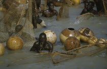 Fishing Festival  men and nets in water at climax to three day festival.African Nigerian Western Africa Male Man Guy Male Men Guy 3