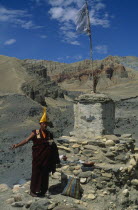 Tibetan Buddhist monk making offerings of incense at a stupa during Lok Khor ceremony in which prayers are made for a good harvest and protection of the home.Asia Asian Nepalese Religion Religion Rel...