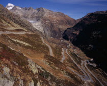 The Upper Rhone Valley with the Grimsel Pass in the foreground. The distant Furka Pass seen winding above. Snow covered Galenstock Mountain 3586metres  11744ft   on the leftEuropean Schweiz Suisse S...