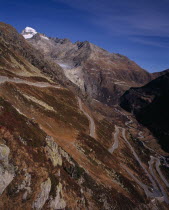 The Upper Rhone Valley with the Grimsel Pass in the foreground. The distant Furka Pass seen winding above. Snow covered Galenstock Mountain 3586metres  11744ft   on the leftEuropean Schweiz Suisse S...