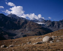 Above Stausee Mattmark. Allalinhorn 4027metres   13188ft   on the left skyline with rocks on the ground in the foregroundEuropean Schweiz Suisse Svizzera Swiss Western Europe Wallis Polynesia Scenic...