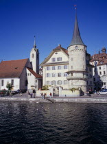 Waterfront buildings on north bank of  River Reuss. St Peterkapelle on the leftEuropean Schweiz Suisse Svizzera Swiss Western Europe Luzern Lucerne Scenic