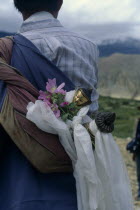 Buddha figure wrapped in ceremonial scarves being carried through the summer fields during Lok Khor festival to bring good harvests and protection.Asia Asian Nepalese Religion Religious One individua...