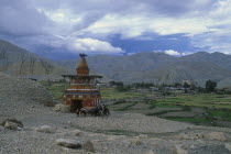 Group of riders on ponies beside stupa marking the entrance to Tsarang.Asia Asian Nepalese Religion Scenic Religious Pony