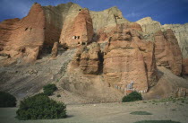 The red cliffs of Drakhmar with Buddhist shrine at the baseAsia Asian Nepalese Religion Religion Religious Buddhism Buddhists Scenic