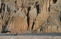 High ranking Tibetan lama and Monks travelling across landscape by sheer cliffs to visit the Kingdom or ChhuksangAsia Asian Nepalese Religion Scenic Traveling Religious