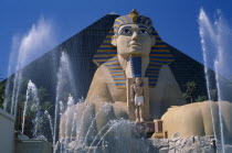 The Luxor Hotel exterior with entrance through life size replica of the Sphinx with fountains in foreground.American North America United States of America