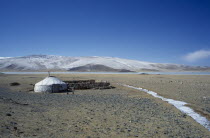 View over Kazakh nomad camp with single yurt and livestock coralAsia Asian Ger Mongol Uls Mongolian One individual Solo Lone Solitary