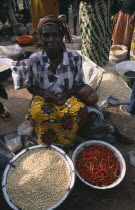 Woman selling chillies and pulses at a market stallAfrican Female Women Girl Lady Nigerian Western Africa Female Woman Girl Lady