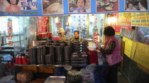 Namdaemun market  street restaurant  women get ready for evenings customers behind stacks of dishesAsia Asian Classic Classical Daehanminguk Female Woman Girl Lady Hanguk Historical Korean Older Trad...