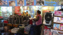 Namdaemun market  street restaurant  women getting ready for the evenings customers behind stack of dishesAsia Asian Classic Classical Daehanminguk Female Woman Girl Lady Hanguk Historical Korean Old...