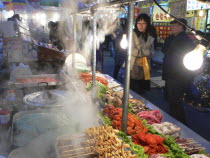Namdaemun - Namdademun market  December evening  steam rising from food stalls  meat and fish  people walking byAsia Asian Classic Classical Daehanminguk Hanguk Historical Korean Older Tradition Warm...