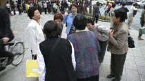 Ginza - group of middle-aged women saying goodbye  well dressed  courtesy bows to each otherAsia Asian Japanese Nihon Nippon Female Woman Girl Lady Female Women Girl Lady Gray Grey