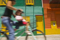 Cyclist passing colourful houses in La Boca.ColourLa BocaHolidaysTourismTravelBuenos AiresSouth AmericaGreenOrangeBicycleBlurArchitectureAmerican Argentinian Color Colorful Hispanic Latin...