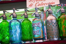 Soda syphons for sale in the San Telmo flea market in Plaza DorregoTravelTourismHolidays ArgentinaBuenos AiresSan TelmoPlaza DorregoFeria de San TelmoSouth AmericaGreenBlueFlea MarketBottl...