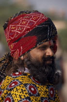 Portrait side profile of a Rajput man with a beard wearing a turban at the Camel FestivalAsia Asian Nepalese Bharat Inde Indian Intiya Male Men Guy Male Man Guy Religion Religious One individual Solo...
