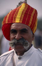 Head and shoulders portrait of a Rajput man with a moustache wearing a turban at the Camel FestivalAsia Asian Nepalese Bharat Inde Indian Intiya Male Men Guy Male Man Guy One individual Solo Lone Sol...