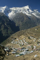 Elevated view over village rooftops of Namche Bazaar with Kwangde Himal mountain in the backgroundAsia Asian Nepalese Scenic