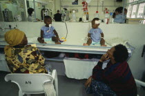 Rondebosch neighbourhood.  Rehydration ward in Red Cross children s hospital.  Child patients receiving treatment with their mothers sitting beside the bed.dehydration African Kids