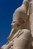 Deir-el-Bari. Hepshepsut Mortuary Temple. Side profile of Osiride statue of Hepshepsut represented as a male with a beard and crossed arms bearing the crook and flail. African Middle East North Afric...
