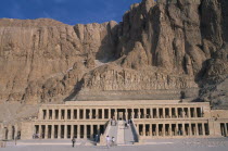 Deir el-Bahri. Hatshepsut Mortuary Temple. Visitors walking towards ramped entrance with limestone cliffs behind.African Middle East North Africa History Religion Religious
