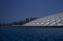 Bibliotheca Alexandrina modern library exterior with detail of interlocking panelled roof seen from across pool of waterOpened in 2002roof was designed to allow as much natural light while avoiding...