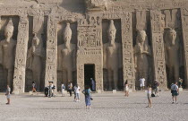 Hathor Temple . Built for Ramses IIs wife Nefertari. Six standing statues caved into facade. Visitors walking in the grounds.African Middle East North Africa Ramesses Religion History Religious 6