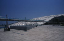 Bibliotheca Alexandrina modern library exterior with view from complex towards long slender bridge leading to entranceMajor library and cultural center African Middle East North Africa Centre Learnin...