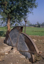 A disused water pump with fields behindAfrican Middle East North Africa Farming Agraian Agricultural Growing Husbandry  Land Producing Raising