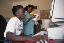 Woman working on computer in WFP Ntiuda Stores supplying convoys to Rwanda and Sudan.World Food Programme African Eastern Africa North Africa Rwandan Sudanese Ugandan Female Women Girl Lady Female Wo...