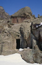 Ancient Geghard Monastery built in the 4th Century AD.  Exterior in snow with carved cross stones set into rock above.Armenian Asia Asian European History Middle East Religion Religious