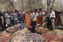 Carpet sellers and customers at Vernisarge weekend market.Armenian Asia Asian European Middle East