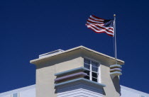 South Beach. Ocean Drive. Detail of an Art Deco building with an American flag flying from the roof American North America United States of America Beaches Resort Sand Sandy Seaside Shore Tourism