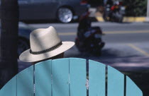 South Beach. Ocean Drive. The head of a man wearing a Panama hat seen above the top of a seat watching people and traffic go byAmerican North America United States of America Beaches Central America...