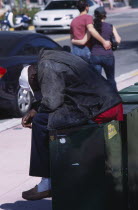 South Beach. Ocean Drive. A Homeless man sitting on a news stand asleep American North America United States of America Beaches Resort Sand Sandy Seaside Shore Tourism Male Men Guy Male Man Guy One i...