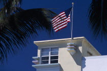 South Beach. Ocean Drive. Detail of an Art Deco building with an American flag flying from the roof American North America United States of America Beaches Resort Sand Sandy Seaside Shore Tourism