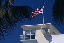 South Beach. Ocean Drive. Detail of an Art Deco building with an American flag flying from the roof American North America United States of America Beaches Resort Sand Sandy Seaside Shore Tourism
